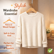 White sweater on a wooden hanger with text highlighting features, in a bedroom setting.